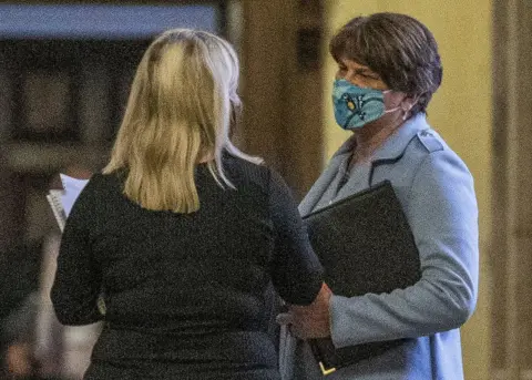 PA Media Arlene Foster speaks to Michelle O"Neill at Stormont's Parliament Buildings