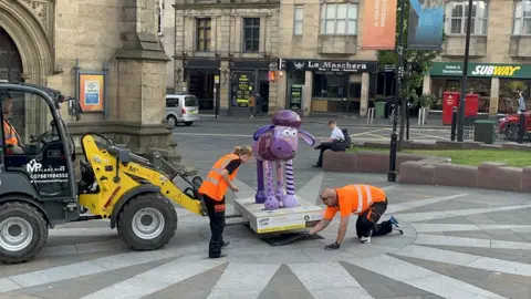 St Oswald's Hospice Shaun the Sheep being put into position by Newcastle Cathedral