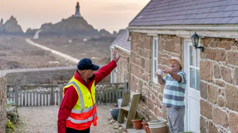 Jersey Post A postman waving