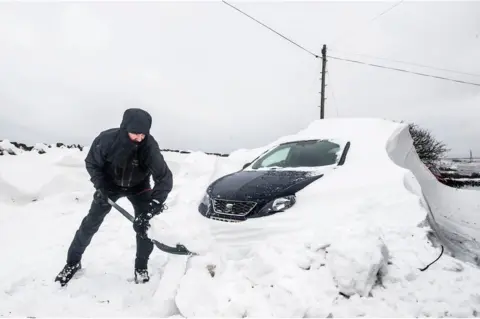 PA A person digging their car out from under heavy snow