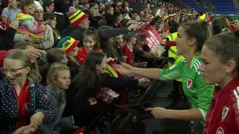 Wales women signing autographs