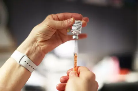 PA Media A nurse preparing a Covid-19 vaccine at a GP surgery in Belfast