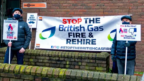 Alamy Workers hold banner saying Stop the British Gas fire and rehire