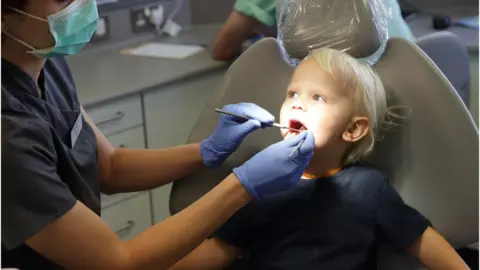 Peter Cade A child in a dental appointment