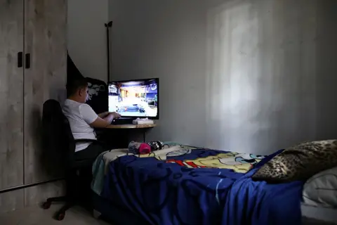 Ammar Awad / Reuters A boy on his computer