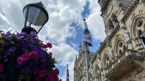 Kris Holland/BBC Windrush flag raised