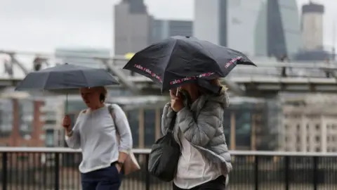 Reuters Woman holding an umbrella in London