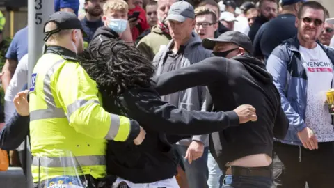 Simon Chapman/LNP Picture of a man punching another man at the rally at Bristol's cenotaph on Saturday