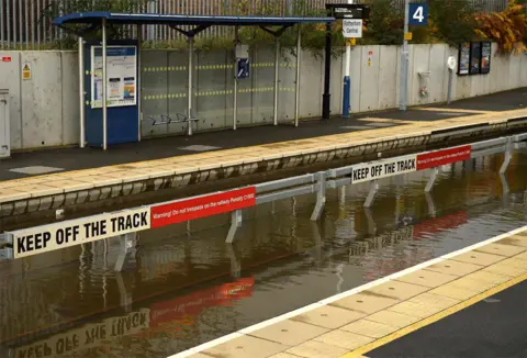 AFP Flood water covering the rail tracks at Rotherham Central train station