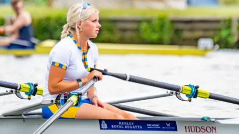 James Finlay A woman rower taking part in the regatta