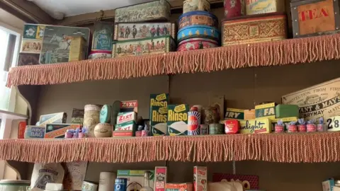 Shop shelves with old packages.