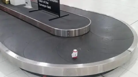 AFP The can on a conveyor belt at Perth Airport