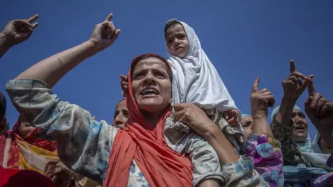 Abid Bhat A woman and child at the demonstration in Srinagar