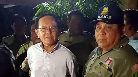 AFP/Getty Images This file photo taken on September 3, 2017 shows Cambodian opposition leader Kem Sokha (L) being escorted by police at his home in Phnom Penh