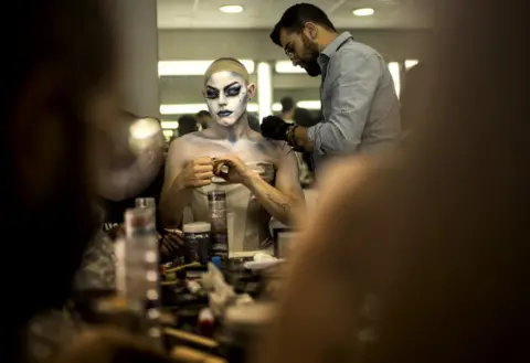 Ida Guldbæk Arentsen Elias has help from a make-up artist as he transforms into Melanie Coxxx