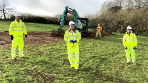 Highways England MP Cherilyn Mackrory, Highways England Senior Project Manager Josh Hodder and Costain Senior Project Manager John Lee