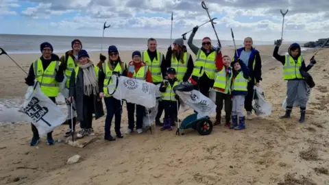 Vattenfall Group of people with bags and grabbers, on a litter pick at Hemsby beach