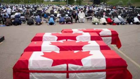 Getty Images A funeral is held for the Afzaal family