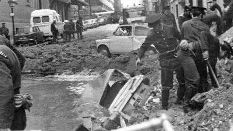 AFP Spanish policemen search among the damages provoked by a bomb attack, 20 December 1973