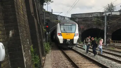 Lily Winnan Passengers on a train near Kentish Town station got off and began walking along the tracks