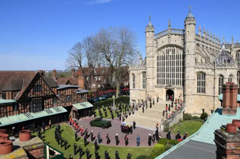 PA Media The Duke of Edinburgh's coffin, covered with his Personal Standard, is carried into St George's Chapel, Windsor Castle, Berkshire, ahead of the funeral of the Duke of Edinburgh