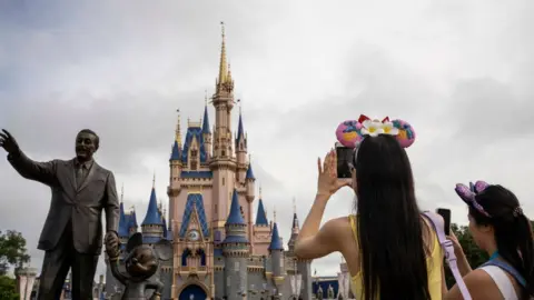 Getty Images A statue depicting Walt Disney and Mickey Mouse in front of the Cinderella Castle at Disney World's Magic Kingdom on Saturday, June 3, 2023 in Lake Buena Vista, Fla.