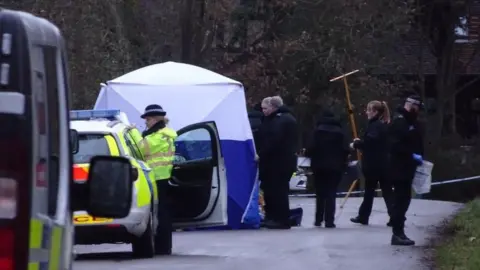 Police officers and tent