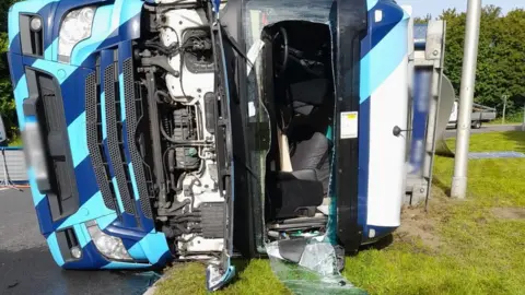 National Highways South West A damaged lorry on its side