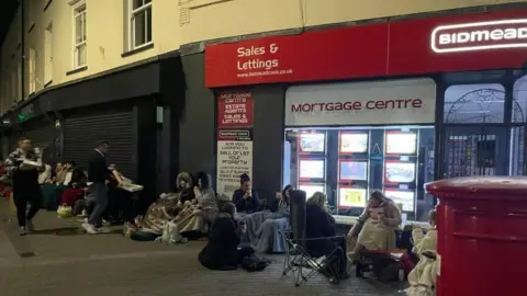 Gavin Williams Queue outside the estate agent