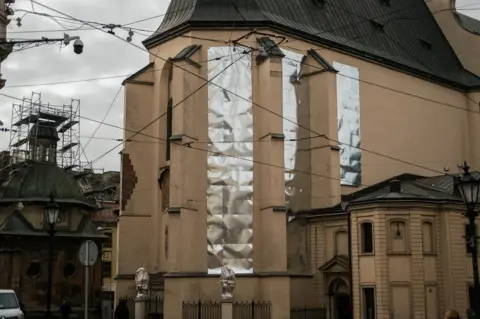 The stained glass windows in churches and cathedrals in Lviv's historic old town have been covered