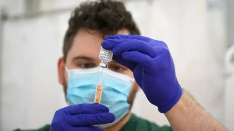 Getty Images An NHS pharmacist preparing doses of the AstraZeneca Covid vaccine in Wadebridge