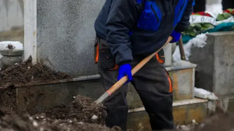 Getty Images Man digging grave