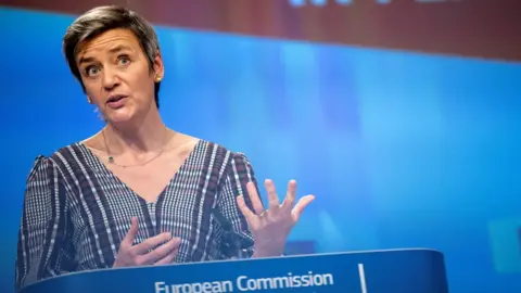 Reuters Margrethe Vestager stands at a European Commission podium