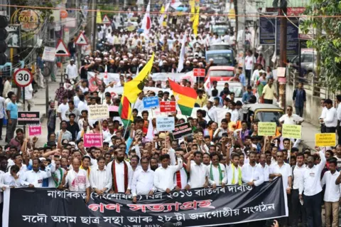 Getty Images Activists in Assam take part in a protest against the a bill that seeks to give Hindu migrants more rights.