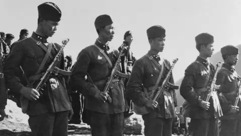 Getty Images Chinese troops are shown standing guard near the Tibet border