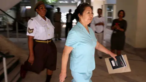 AFP Yang Fenglan leaves court, Dar Es Salaam, 2016