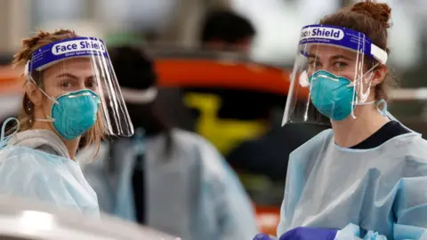 Getty Images Medical staff perform COVID-19 testing at a drive through testing site in South Melbourne on May 26, 2021 in Melbourne, Australia.