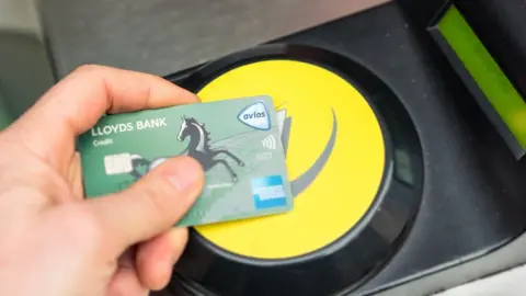 Getty Images A Lloyds credit card tapped on an Oyster Card reader