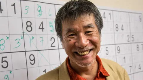 Japanese puzzle manufacturer Maki Kaji poses for a picture during the Sudoku first national competition in Sao Paulo, Brazil, on 29 September 2012