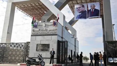 AFP Portraits of Egyptian President Abdel Fattah al-Sisi and Palestinian leader Mahmoud Abbas hang at the Rafah border crossing with Egypt on 1 November 2017