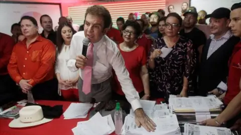 Reuters Salvador Nasralla, presidential candidate for the Opposition Alliance Against the Dictatorship, shows the tallies of ballot counting during a news conference in Tegucigalpa, Honduras November 29, 2017.