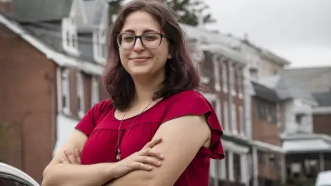 Jose Moreno Describing Trump, Beth Jacksier, standing in front of her house