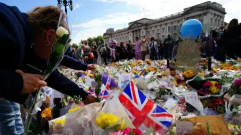 PA Media Floral tributes at Buckingham Palace