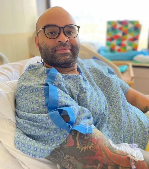 US Navy Thomas James lying in a hospital bed.