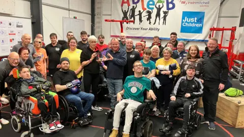 Martin Giles/BBC Gym users and staff at Able2B gym in Norwich