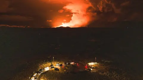 Jakob Vegerfors People look on as magma and heat billow from volcanic eruption in Iceland