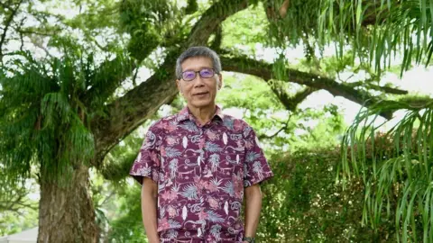 BBC/Tessa Wong Russell Heng in Singapore's Esplanade Park