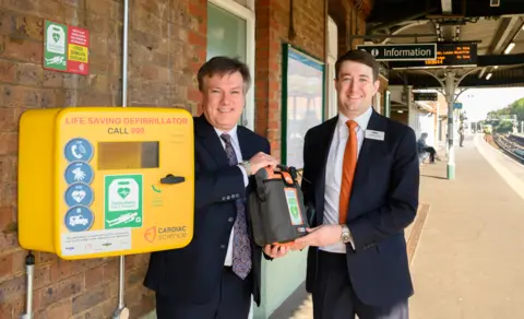 Govia Thameslink Railway Man holding a defibrillator