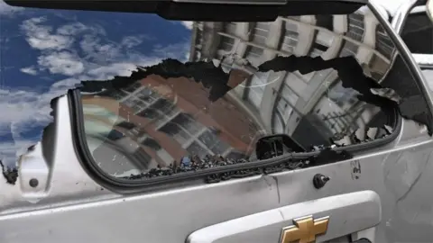 AFP View of the damaged rear window of a vehicle after supporters of Venezuelan President Nicolas Maduro attacked a convoy of opposition lawmakers