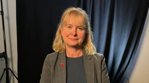 BBC Celia Webster, a woman with light hair wearing a tweed jacket